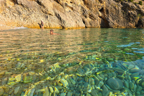 Pláž u jeskyně Plave grote (Modrá jeskyně), ostrov Cres, Chorvatsko
